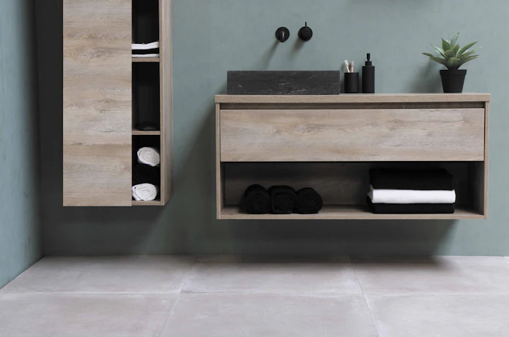 Wall-hung timber vanity with a stone basin and tall storage unit