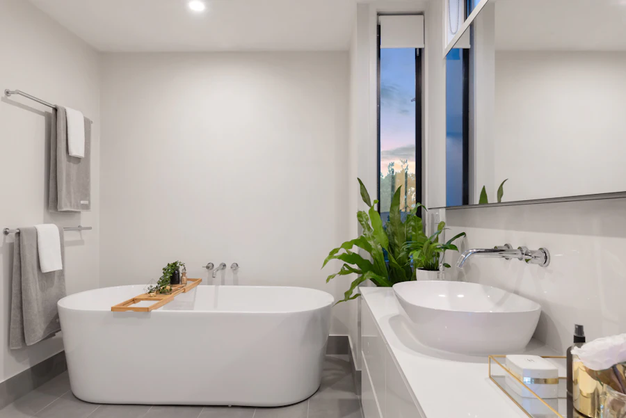 White bathroom with a freestanding bath, vessel basin and wall-mounted taps